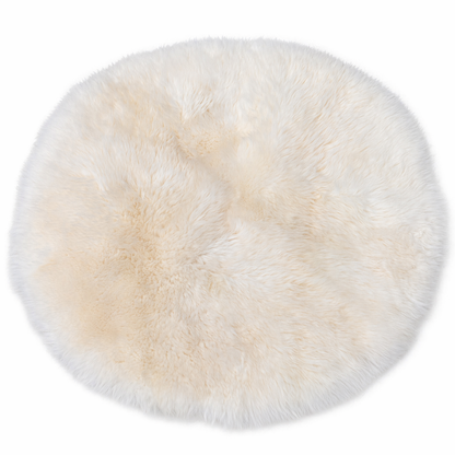 Round ivory long wool shepskin rug on a white background