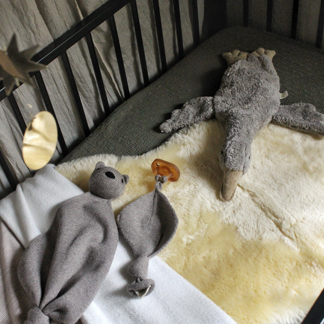 Natural sheepskin baby rug in baby cot